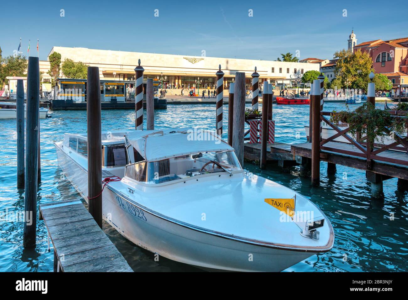 Immagine simbolica di Venezia: Le gondole ormeggiate tra i pali del Canal Grande, di fronte alla stazione ferroviaria di Santa Lucia Foto Stock