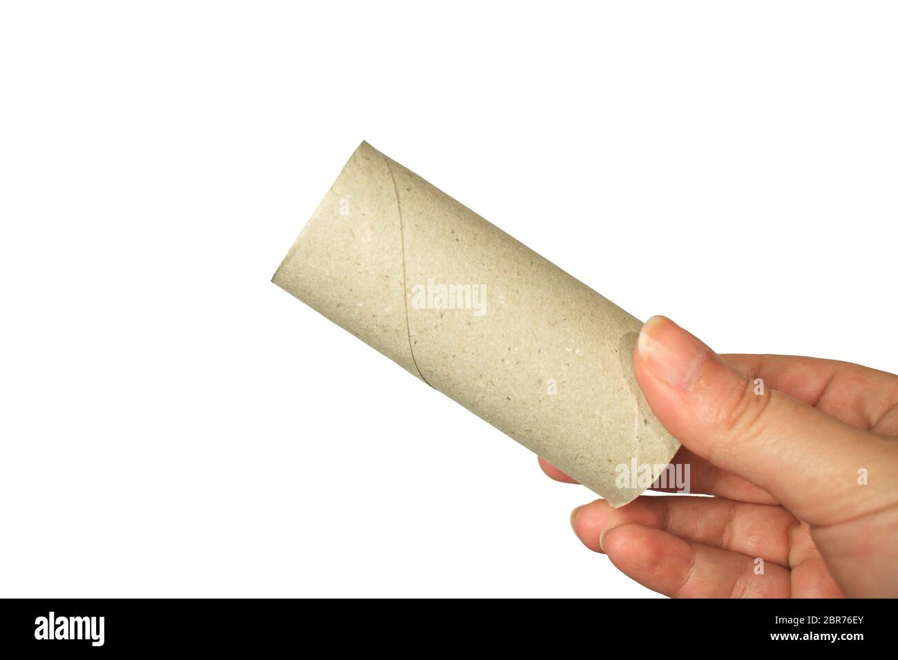 Una mano tiene un rotolo di carta igienica vuoto Foto Stock