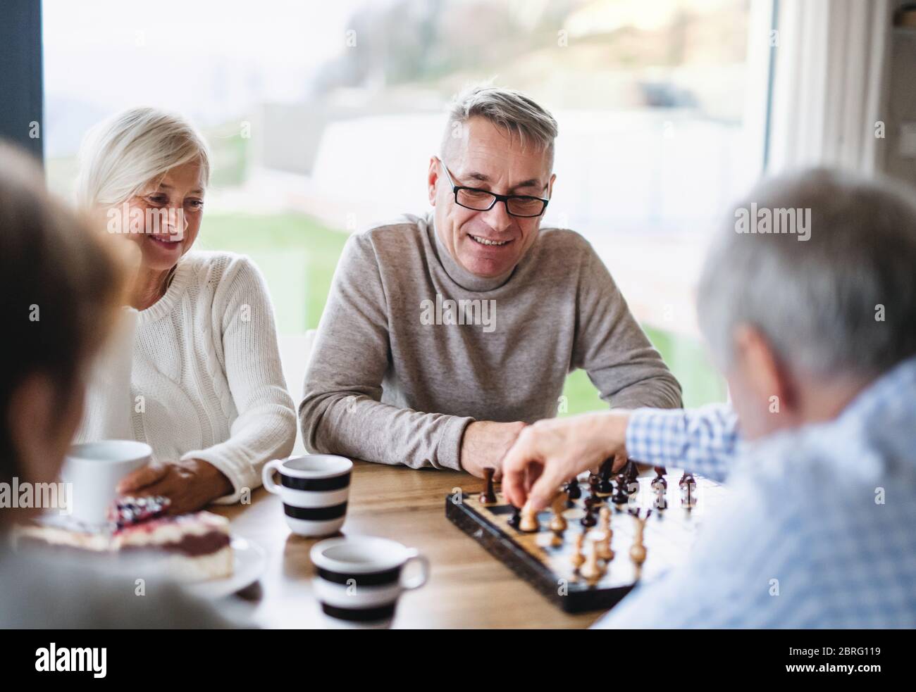 Gruppo di amici senior a casa, giocando a giochi da tavolo. Foto Stock