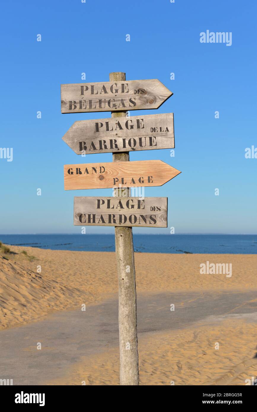 Pannello di legno nella sabbia che indica in francese : spiaggia di Beluga, spiaggia di Barrel, spiaggia grande e chardon Beache, nomi di spiagge atlantiche in atlantici Foto Stock