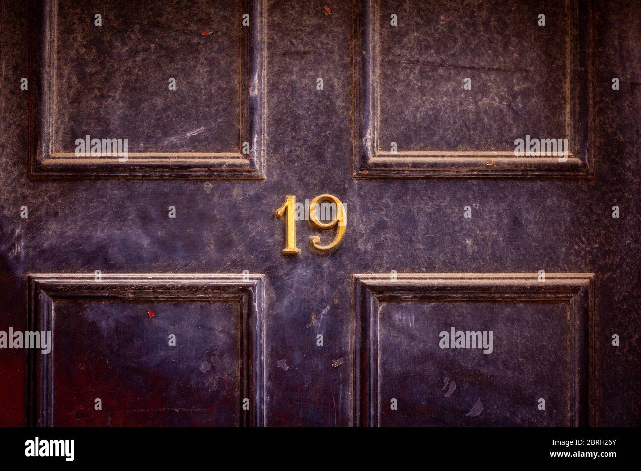 Casa numero 19 su una porta di fronte di legno scuro a Londra Foto Stock