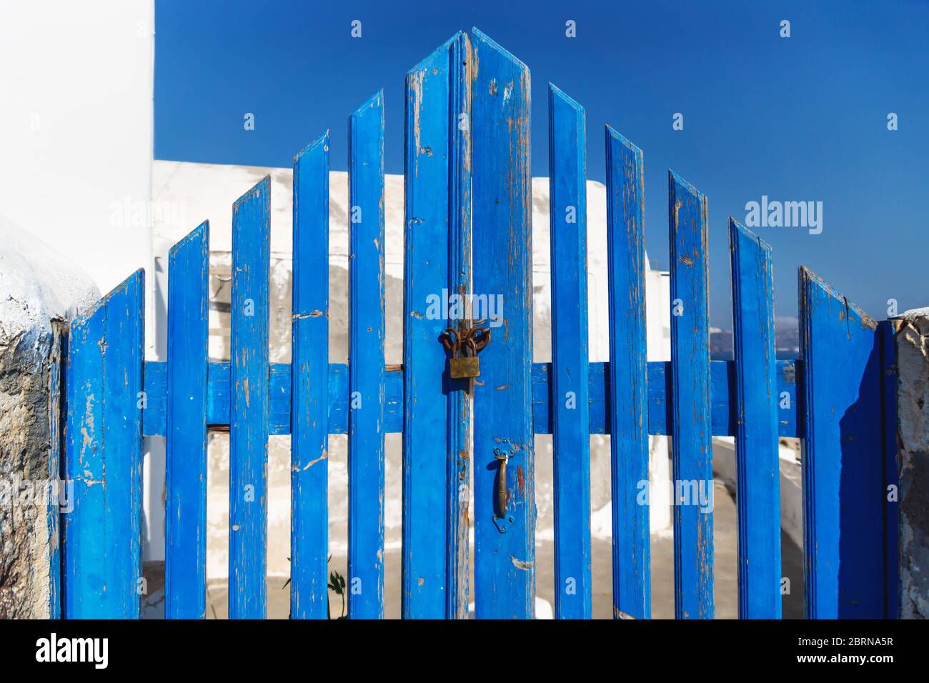 Tipico recinto greco di legno blu a forma di triangolo chiuso con serratura, Oia, Santorini, Grecia Foto Stock