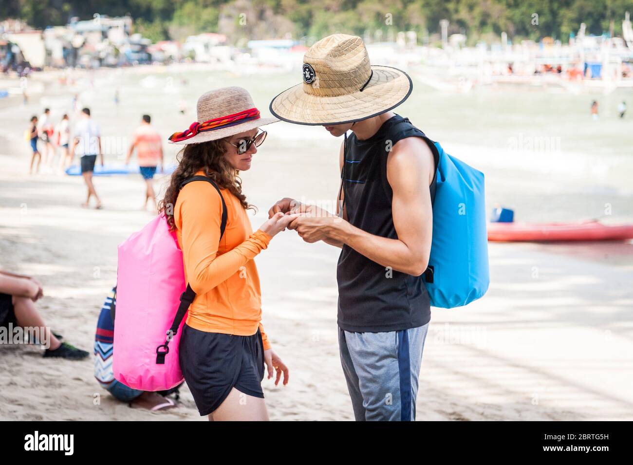 Scena mattutina sulla spiaggia principale di El Nido, Filippine, mentre i turisti iniziano a dirigersi sulle barche da giorno. Foto Stock