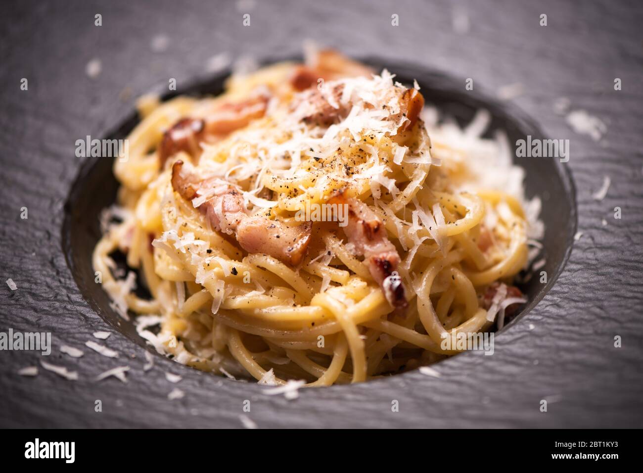 Spaghetti carbonara su un piatto nero primo piano Foto Stock