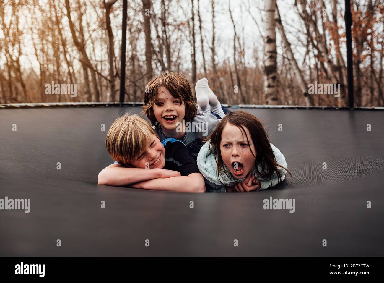 Tre bambini che giocano su un trampolino, USA Foto Stock