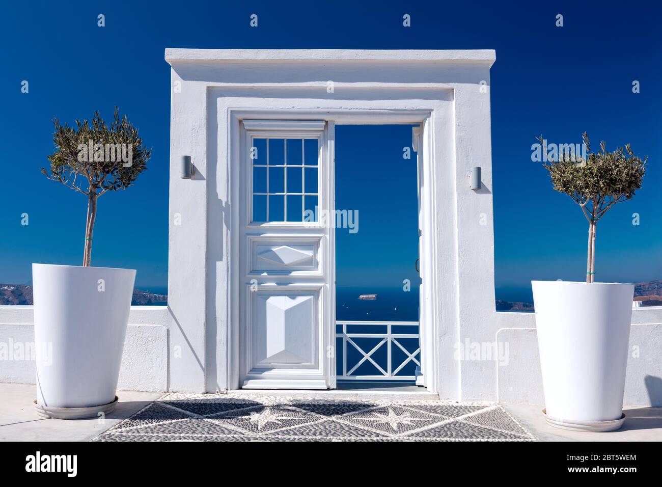 Blu e bianco idilliaco - porta, cancello o ingresso in legno bianco vista mare sull'isola di Santorini nel villaggio di Oia, Grecia. Benvenuti in un resort di vacanza Foto Stock