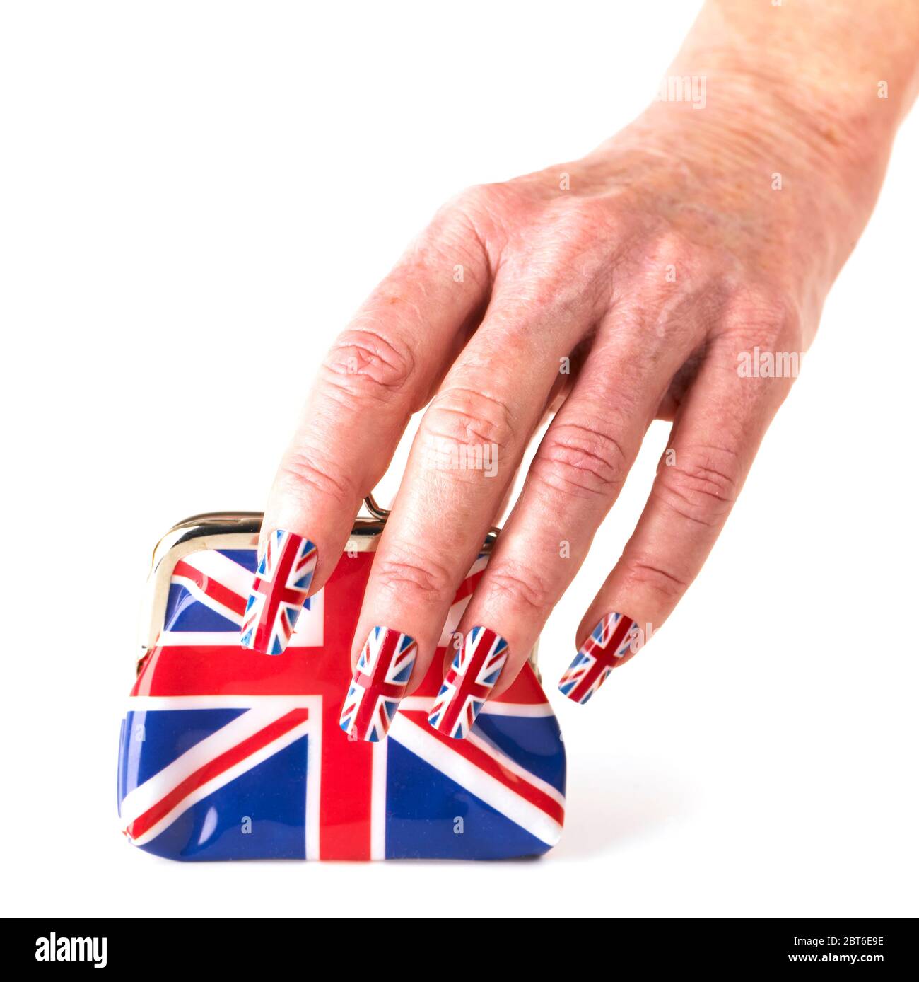 Mano che indossa Union bandiera falsi chiodi che tengono Union jack borsetta Foto Stock