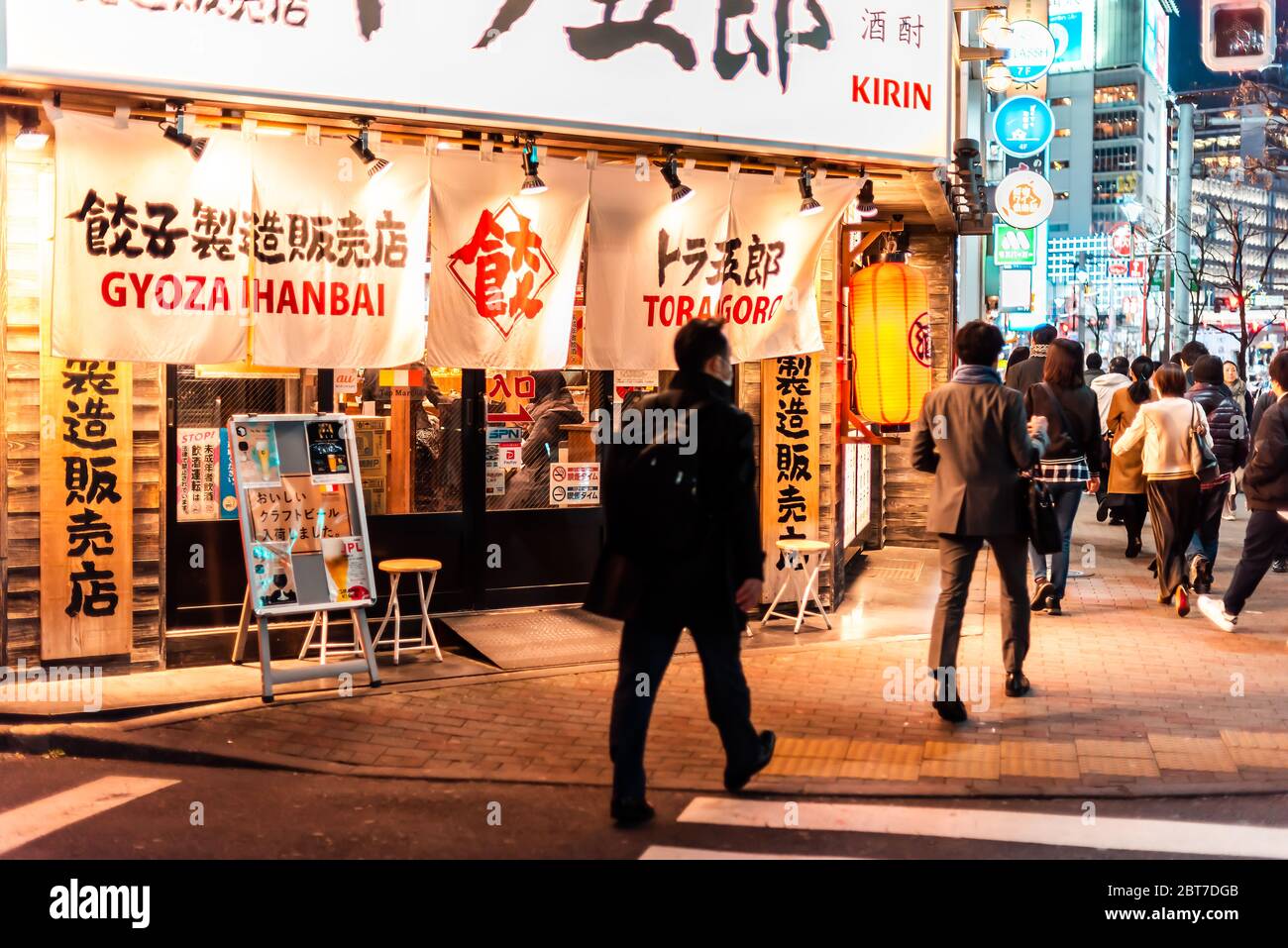 Shinjuku, Giappone - 3 aprile 2019: Strada laterale di Kitashinjuku al ristorante Hyakunincho store cafe con cartello di Gyoza e gente che cammina la sera Foto Stock