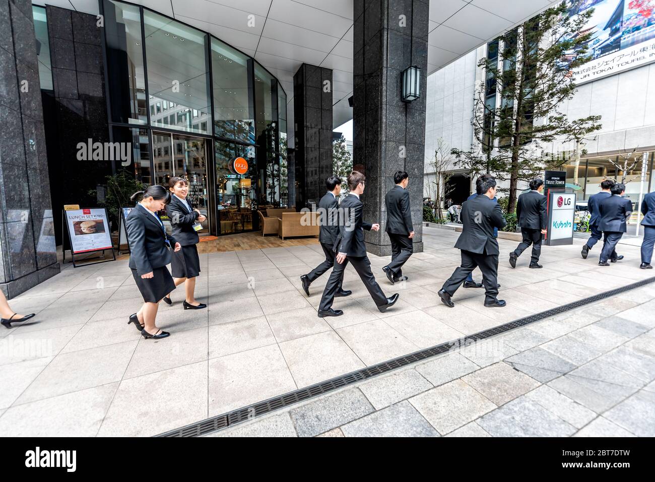 Tokyo, Giappone - 1 aprile 2019: Kyobashi Edogand moderno edificio del centro affari con l'architettura LG segno di ingresso e molte giovani donne d'affari Foto Stock
