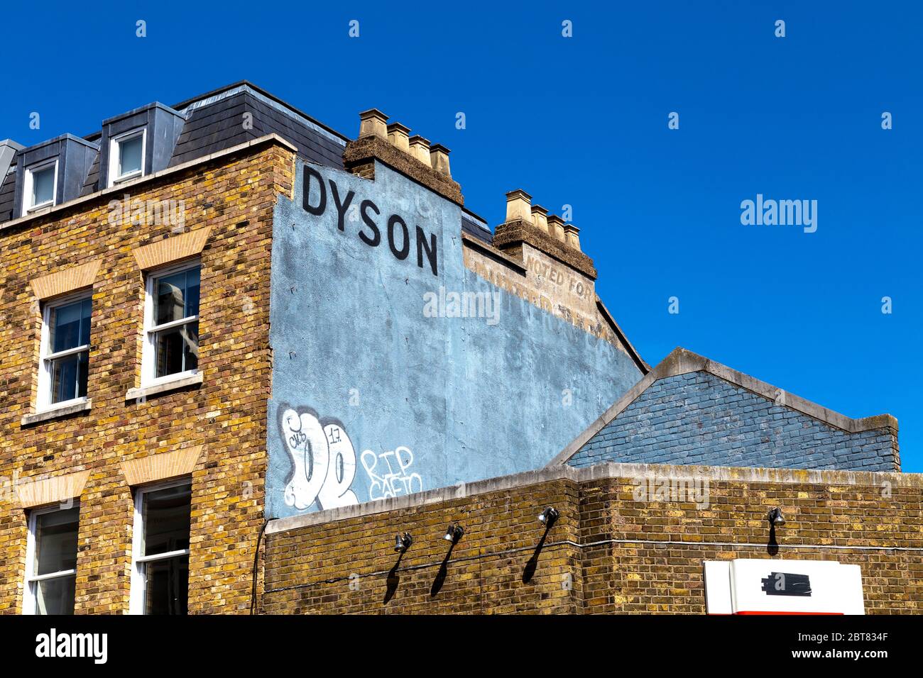 Murale dicendo Dyson al lato di un edificio di mattoni gialli a Dalston, Londra, Regno Unito Foto Stock