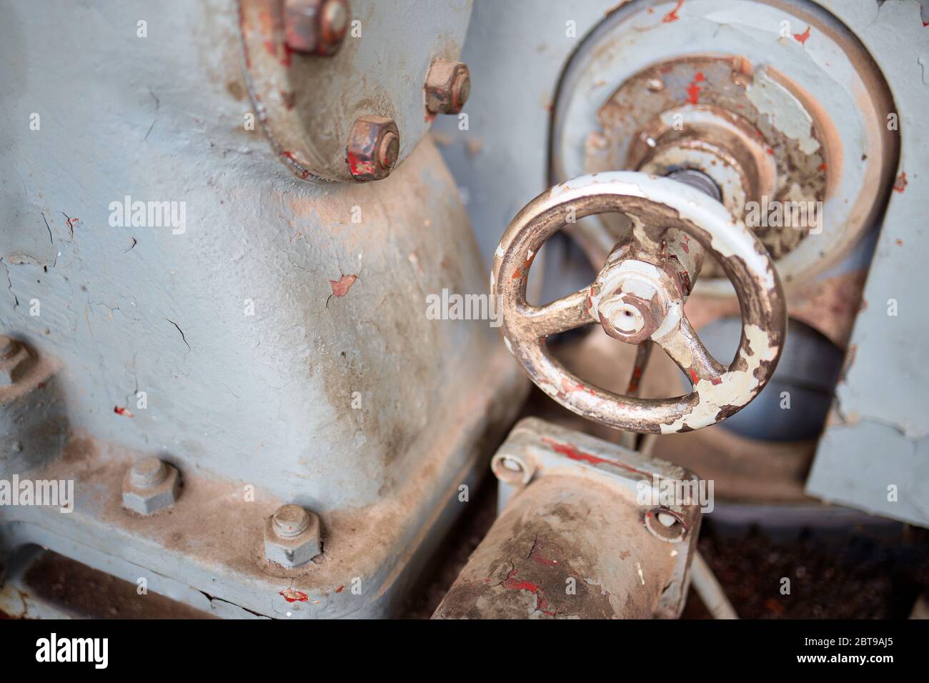 Valvola su alloggiamento di pompa di macchina industriale pesante o compressore di produzione petrolchimica retro design verniciato con vernice rossa e grigia con rigonfiamento Foto Stock