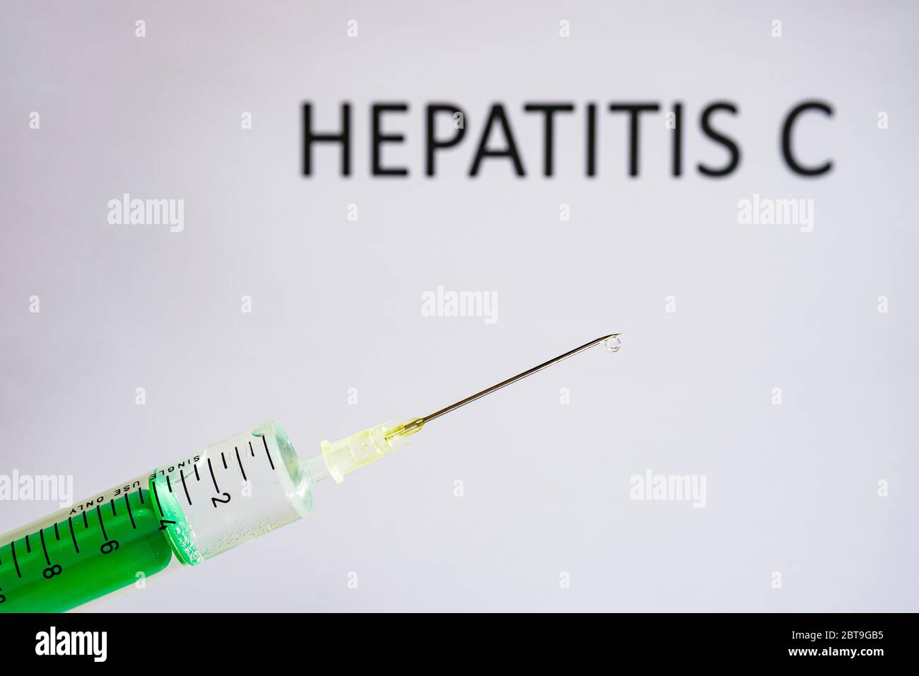 Questa figura mostra una siringa monouso con ago ipodermico, HEPATITIS C scritta su una lavagna bianca dietro Foto Stock