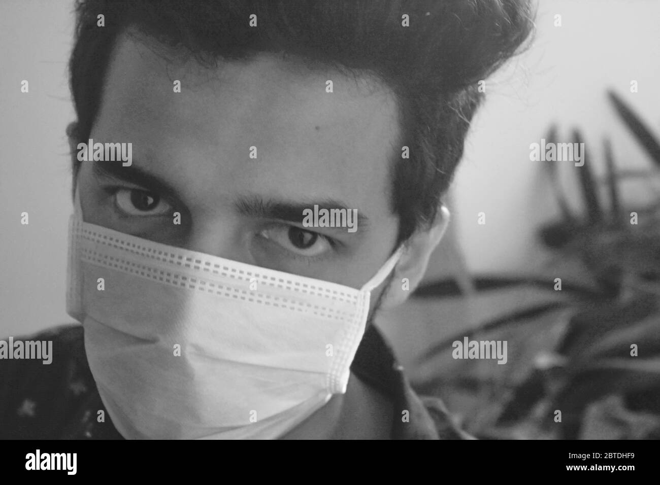 ha concetto di prevenire la diffusione del virus epidemico corona. uomo che indossa maschera facciale e guardando la fotocamera., foto in bianco e nero. Foto Stock