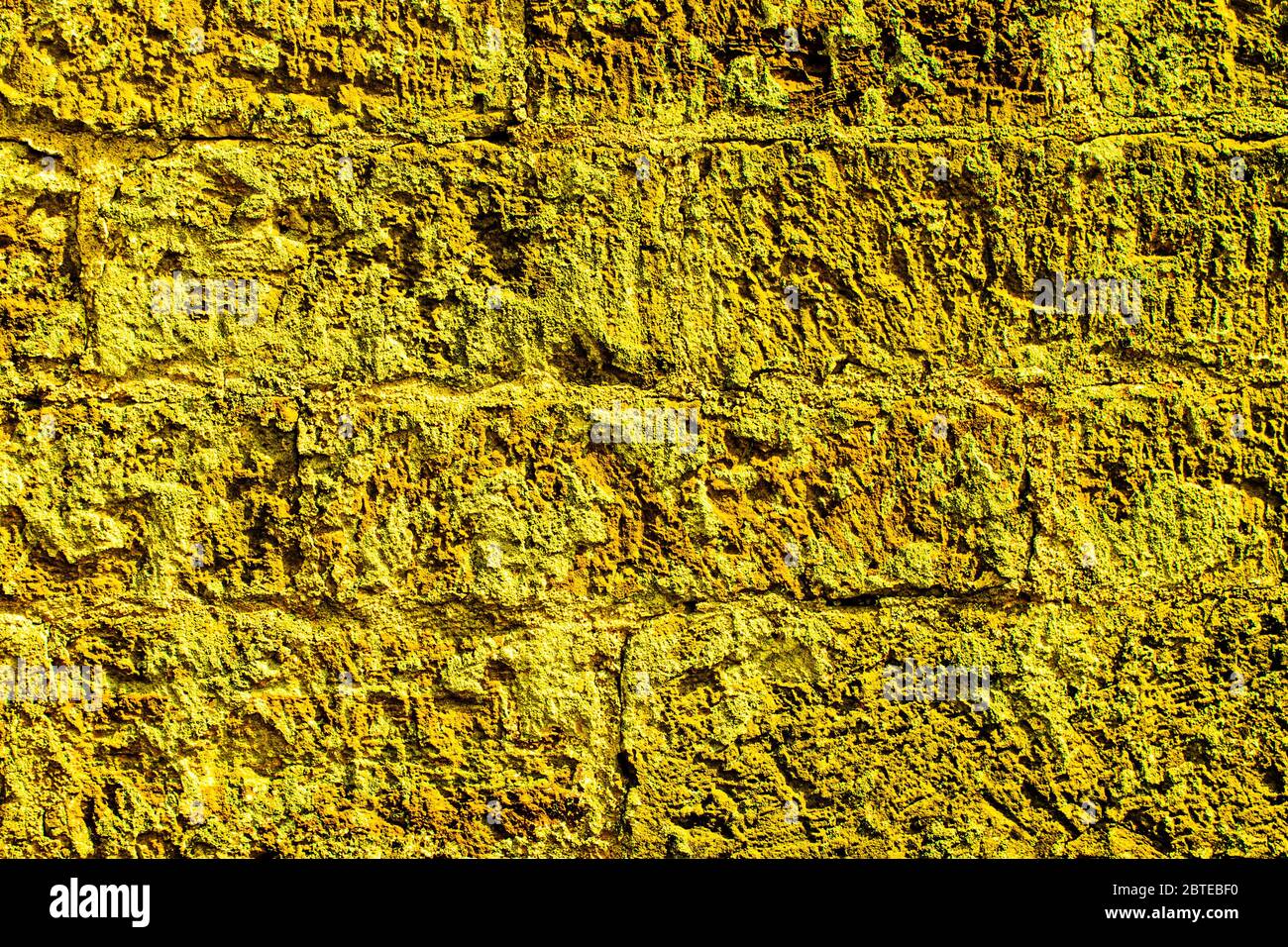 Struttura della parete di mattoni di arenaria gialla per lo sfondo Foto Stock