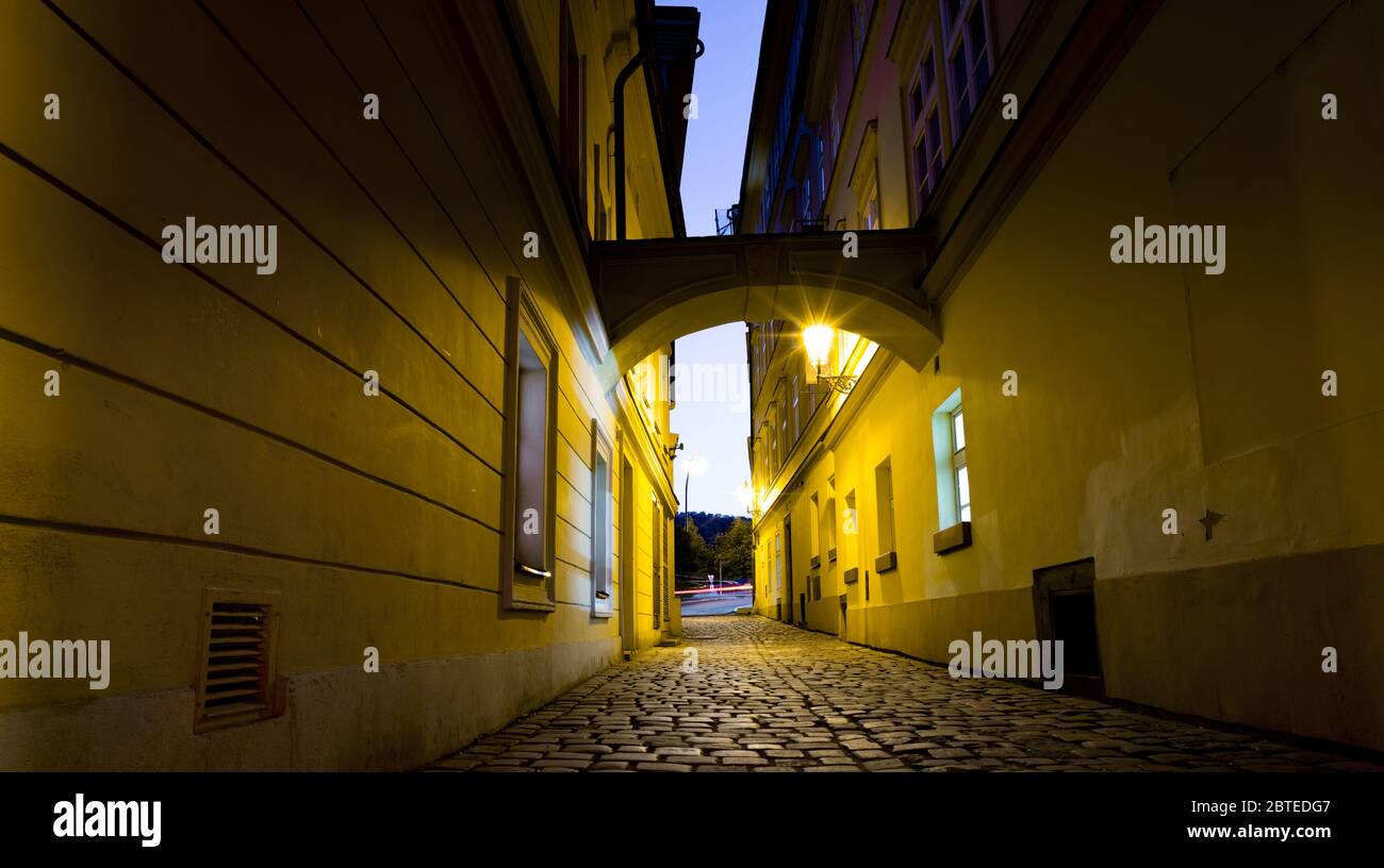 Strada notturna della vecchia Praga sotto la luce delle lanterne Foto Stock