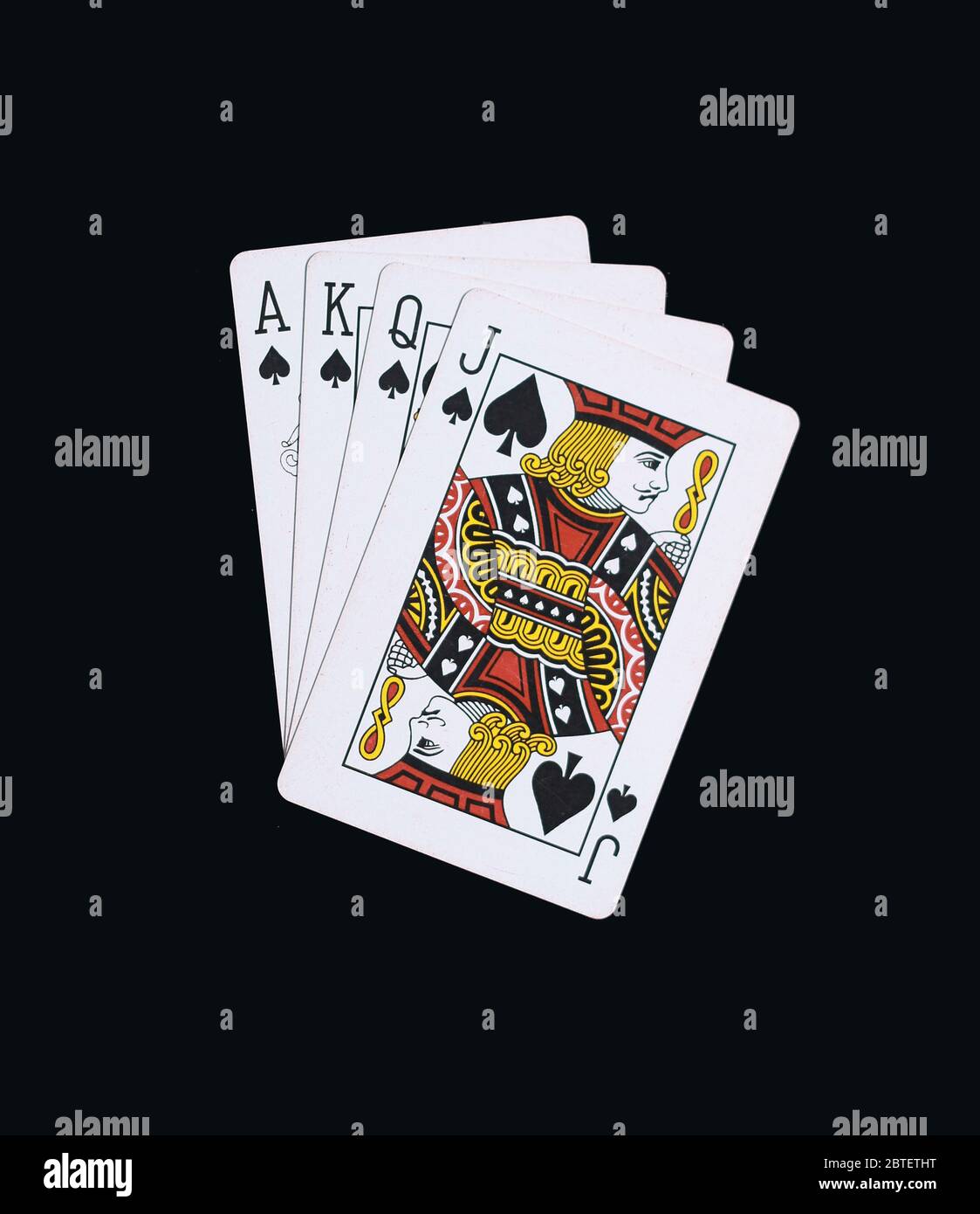 Le pate di poker di J Q K A carte da gioco isolate su nero Foto Stock