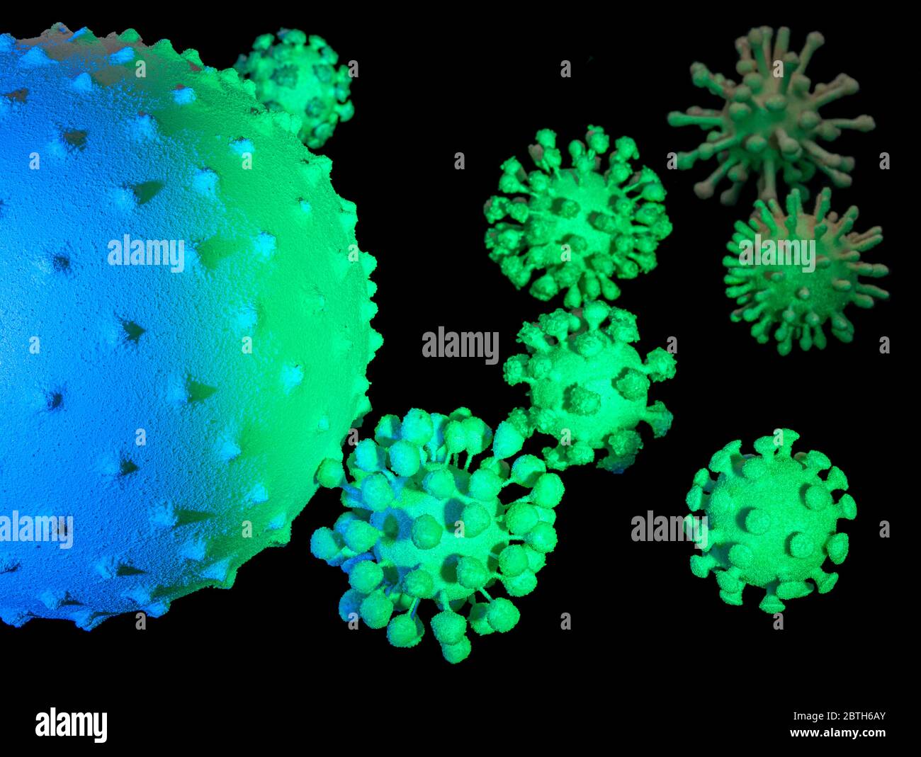 immagine di alcuni colorati virus simbolici illuminati sul retro scuro Foto Stock