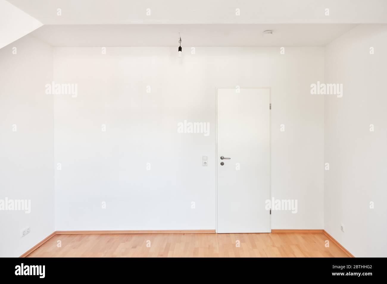 Camera vuota con pareti bianche e porta chiusa dopo il rinnovo Foto Stock