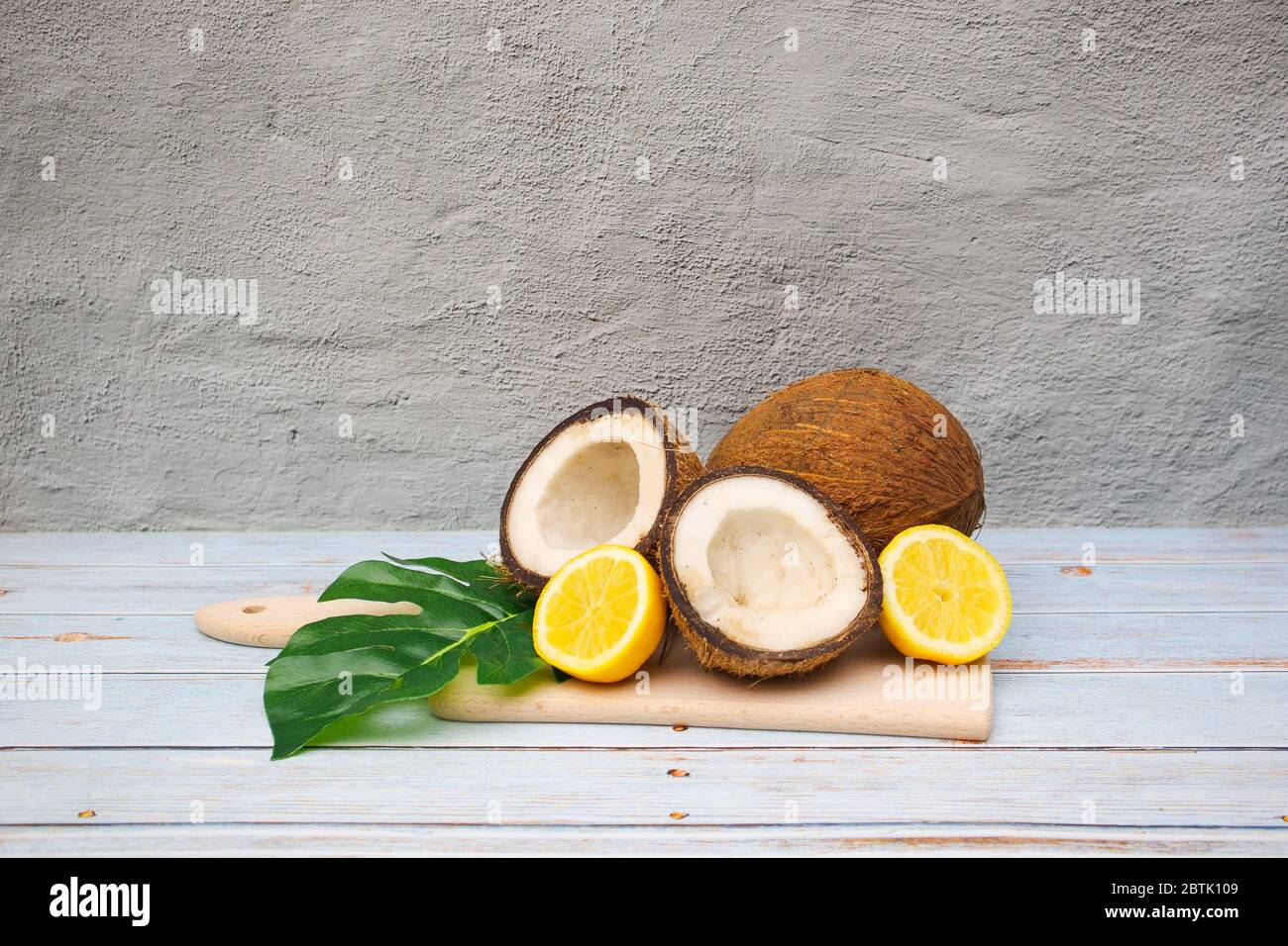 Cocco e limoni sul tagliere Foto Stock