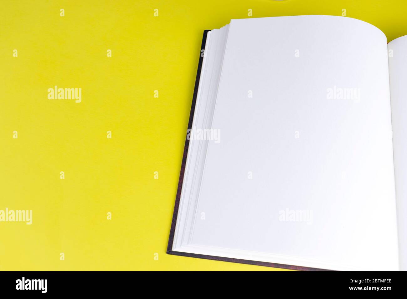 Svuotamento della stampa di opuscoli con pagine vuote e spazio di copia su sfondo giallo. Vista dall'alto. Modello per riviste, portfolio e cataloghi Foto Stock
