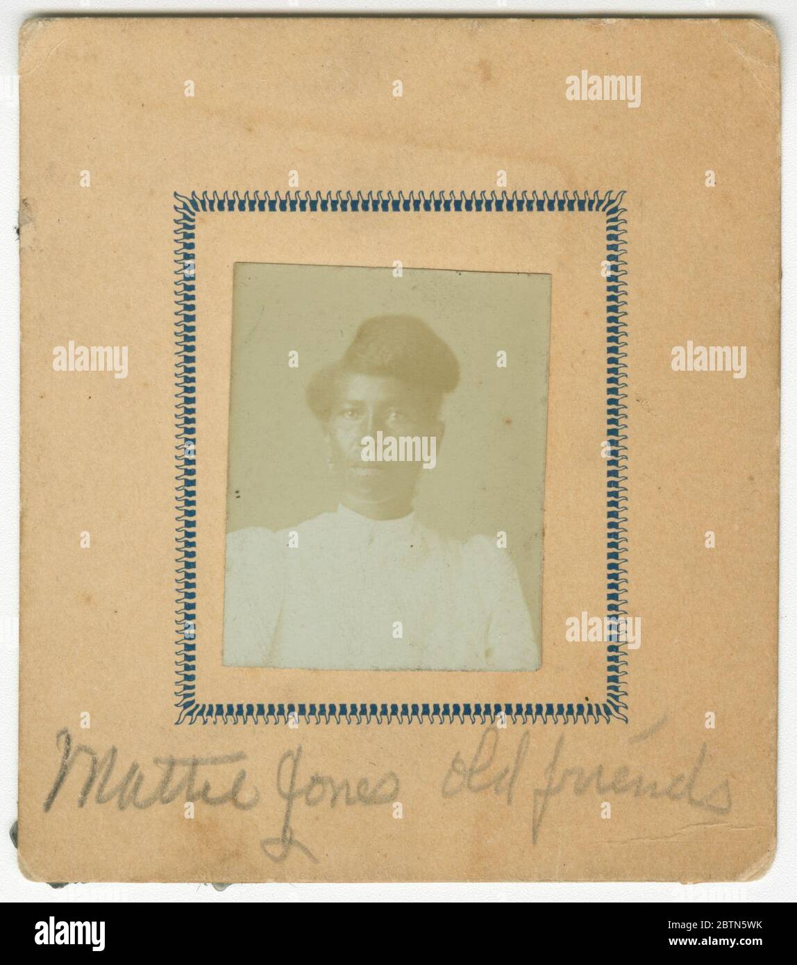 Fotografia di Mattie Jones. Una foto di una donna che indossa un abito bianco con spalle e orecchini gonfi. La fotografia è in una carta color crema. Scritto in fondo alla carta è 'Mattie Jones Old Friend'. Non c'è iscrizione sul retro. Foto Stock