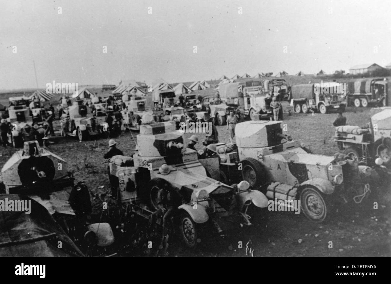 Le auto blindate britanniche sono in allerta dopo una battaglia con gli arabi. Foto: Equipaggi con timoni di un'unità blindata britannica riposano con macchine al loro campo mentre stanno seguendo una battaglia con i terroristi arabi vicino a Nablush, uno dei punti di pericolo nelle rivolte anti-ebraiche palestinesi. 17 settembre 1936 Foto Stock