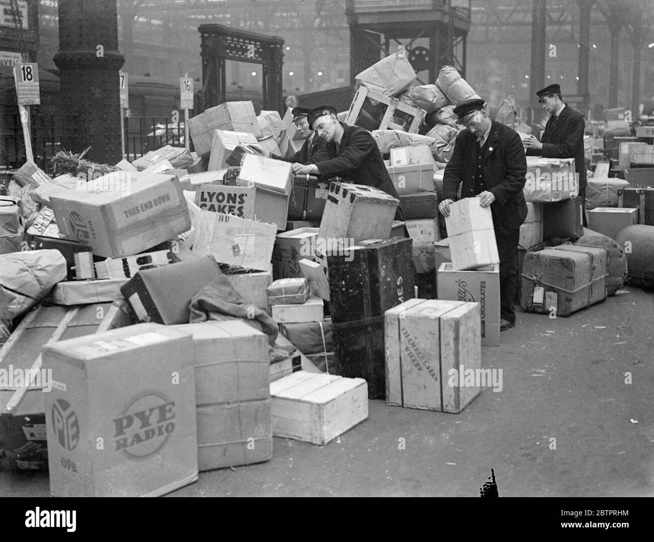 Pacco di Natale a Waterloo. Tonnellate di migliaia di pacchi natalizi e tonnellate di mail di Natale sono in corso di gestione alla stazione di Waterloo , dove il personale lavora a piena pressione per affrontare la corsa. 21 dicembre 1937 Foto Stock