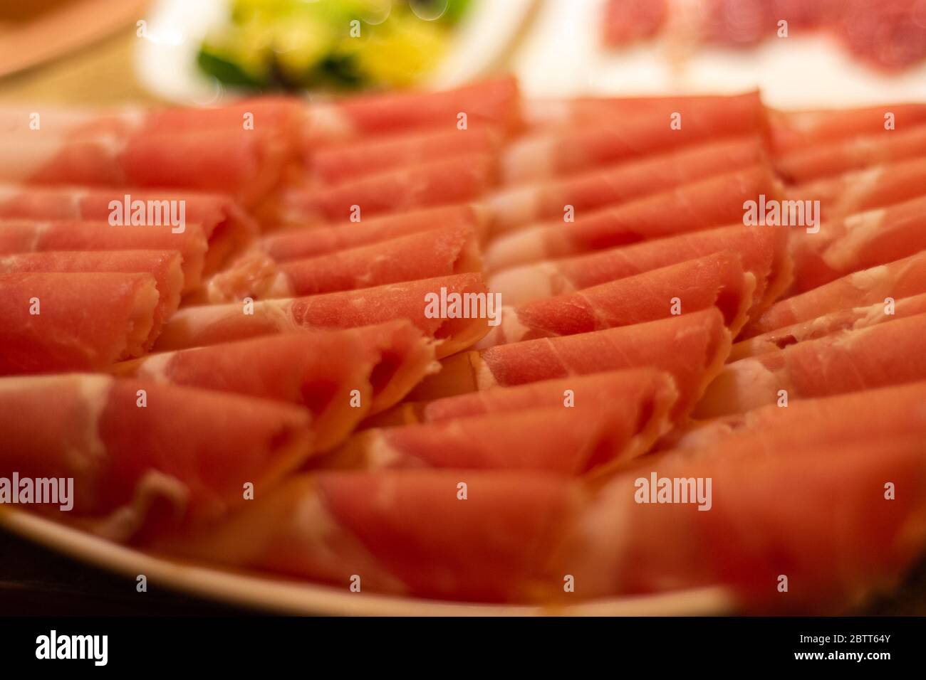 Sottili fette di carne di manzo, pronte per essere cotte in pentola calda, piatto popolare cinese Foto Stock