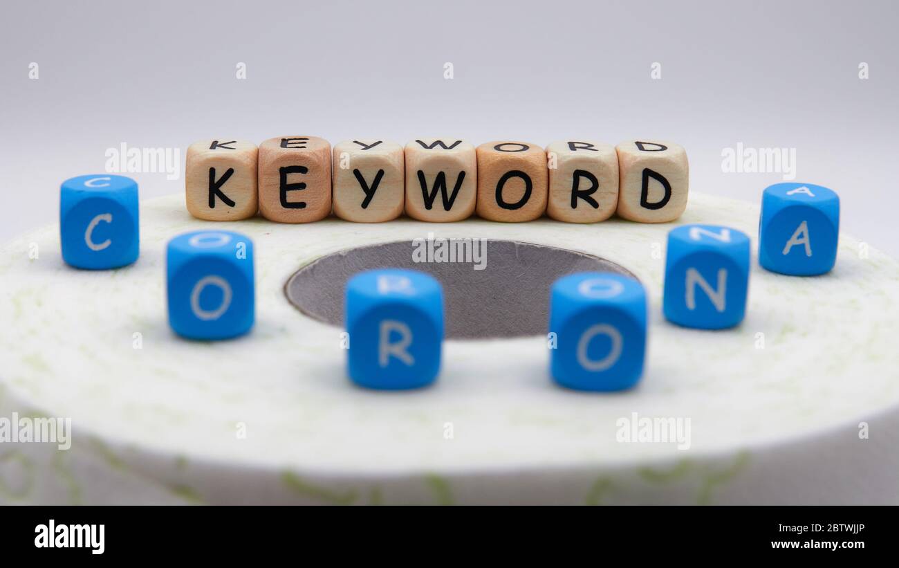 Parola chiave corona su carta igienica verdastra fuori fuoco Foto Stock