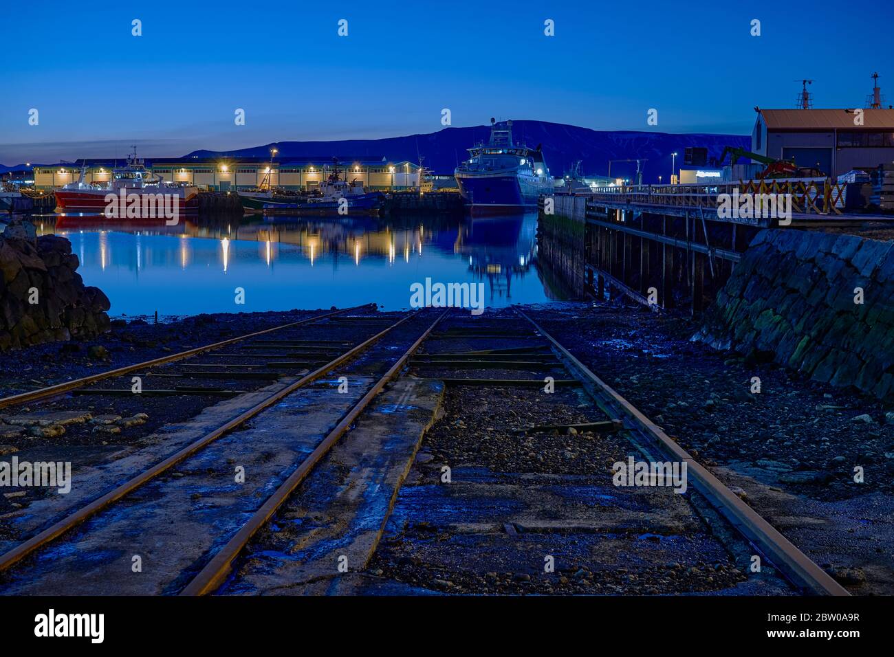 Vista notturna della prima estate sul porto di Reykjavik, barche, luci nella luce blu di mezzanotte Foto Stock