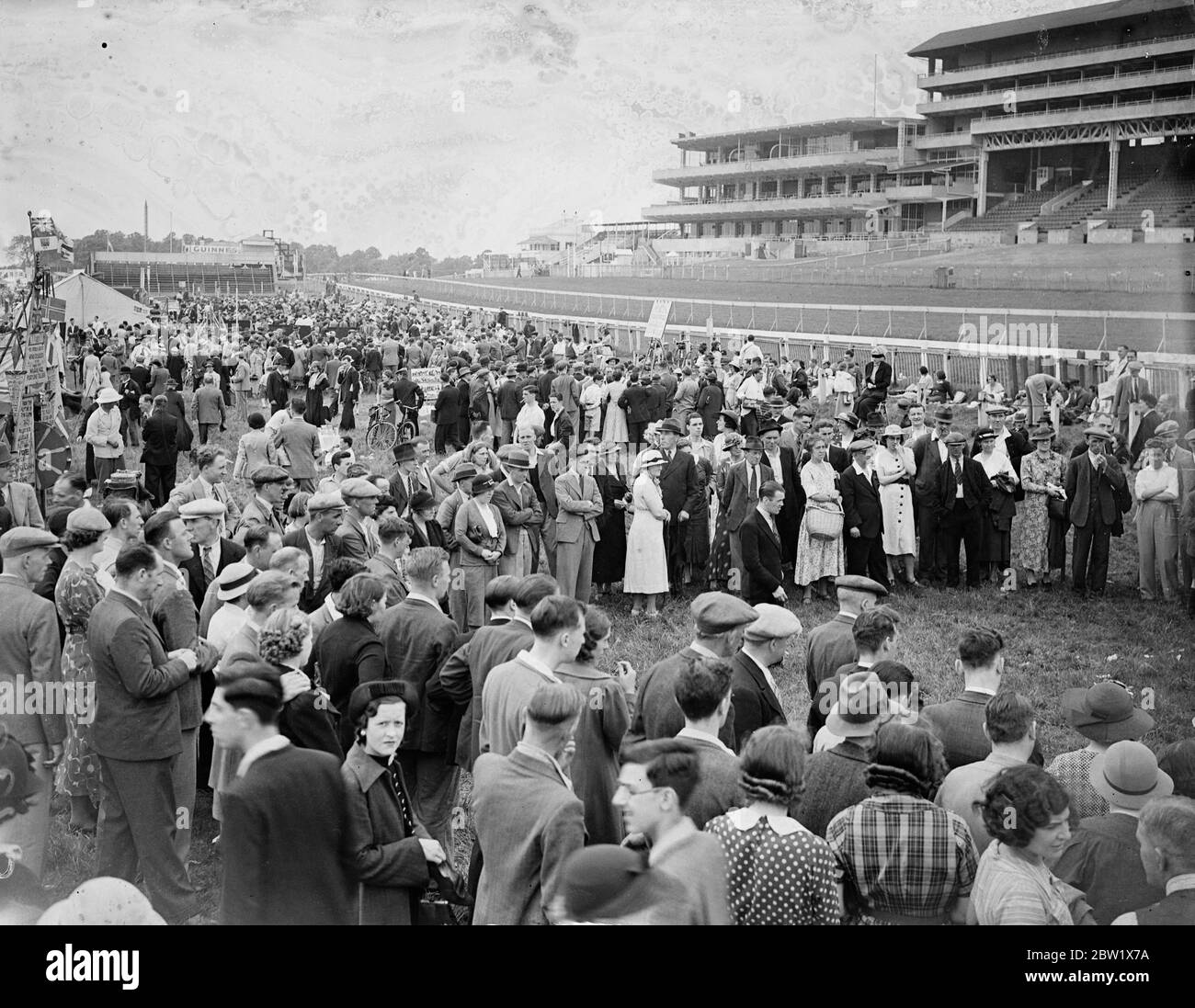 Grandi folle di Derby Domenica dal corso Epsom. Favorita dal tempo estivo reale, grandi folle si sono riunite per ispezionare il corso di Derby a Epsom oggi (Domenica di Derby). Tutte le figure colorate che rendono l'evento più famoso di Derby Day Racing, erano sul campo. Spettacoli fotografici, la grande folla di Derby Domenica che sfrontano il corso a Epsom. 30 maggio 1937 Foto Stock