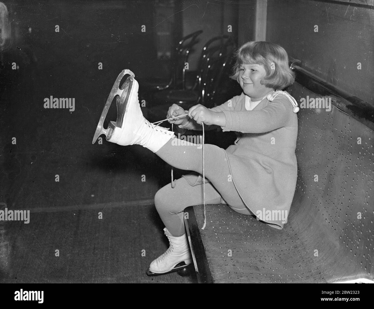 La più giovane pattinatrice svedese sul ghiaccio a Londra. Birthe Holmberg, sette anni, è arrivata a Londra ed ha già iniziato la sua mostra di pattinaggio presso il Queens Ice Club di Bayswater. Birthe era un medalista di bronzo a sei anni e cinque mesi. Spettacoli fotografici, Birthe Holmberg, di sette anni, mettendo le sue scarpe da pattinaggio al Queen's Club. 20 settembre 1937 Foto Stock
