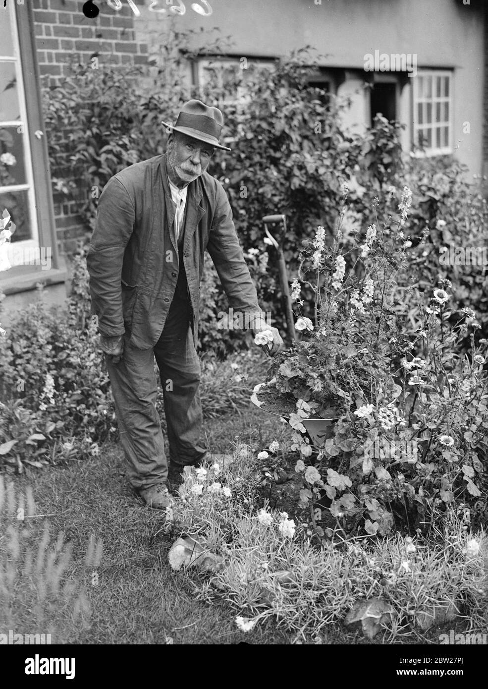 Da una piccola locanda nel pittoresco villaggio Essex di Bardfield, antichi artigiani e personaggi tipici locali sono a trasmettere in America un'impressione di vita rurale inglese come è stato per secoli. Nell'esordiente dell'Aquila diffusa il guaritore locale della verruca, Uppy, due thatcher professionisti e il professor Harold Laski parleranno nel microfono e il mio ospite, il sig. Harry Barnes, chiuderà il programma con ultimi ordini e tempo, gentleman, per favore. Mosè drenò, uno degli uomini che avrebbe dato un discorso a casa che si stentava sul lavoro nel suo giardino cottage. 10 luglio 1937 Foto Stock