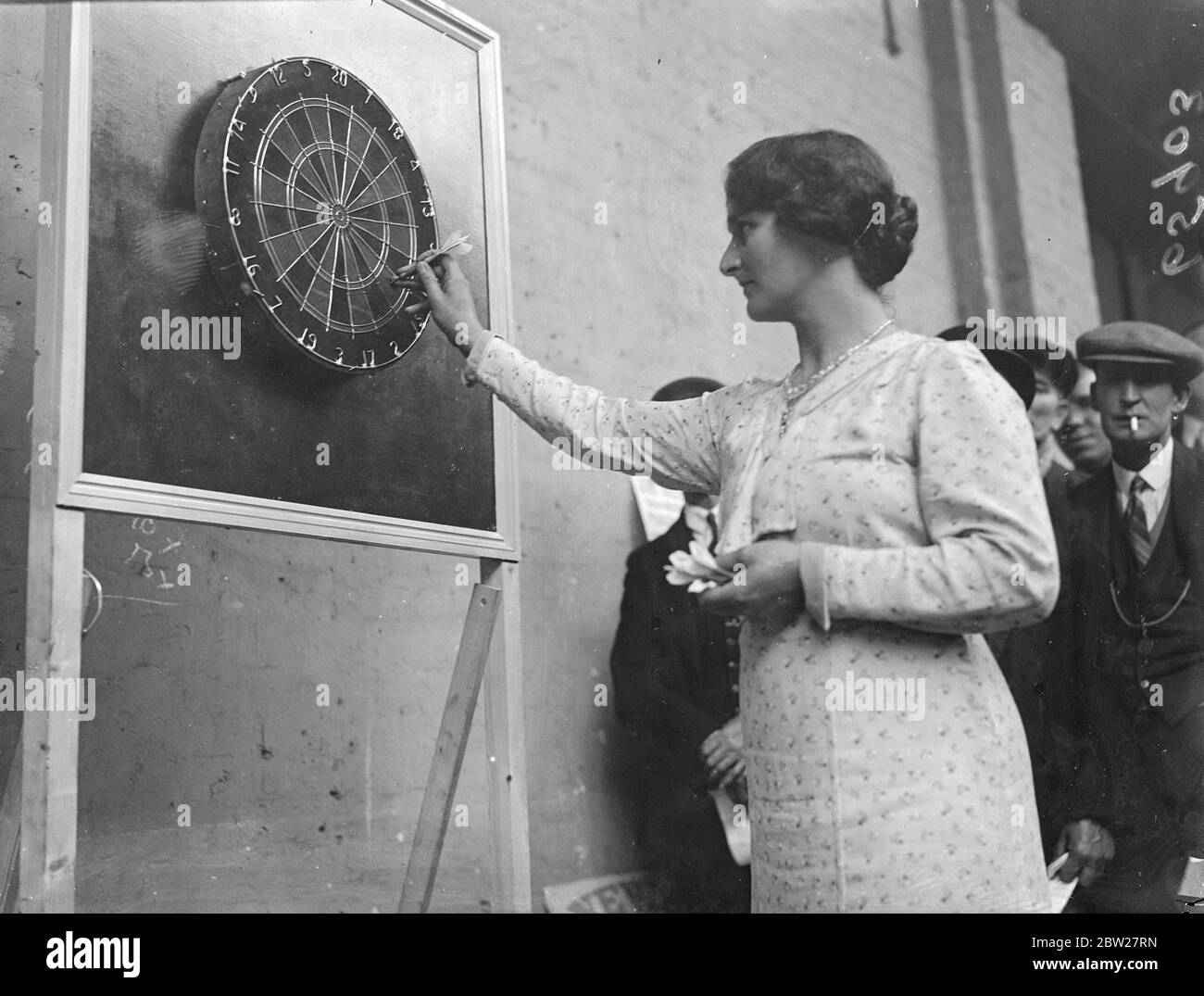 Prima donna sfidante per il campionato di freccette a Islington. Gareggia contro 31 uomini. La prima donna che si qualifichi per le finali finali, la signora a Morgan, di Winchester sta gareggiando nei singoli campionati di freccette presso la Royal Agricultural Hall di Islington. Sta competendo contro 31 uomini, tutti campioni. Foto mostra, Mrs A Morgan in gioco contro il signor J Boy di Oxford nel campionato delle freccette. 24 giugno 1937 Foto Stock
