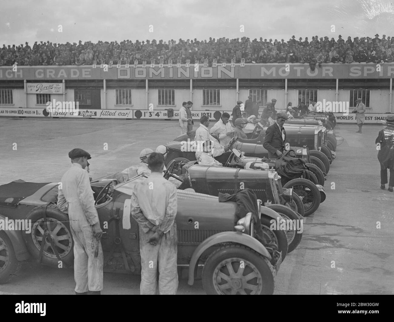 Una gara da vicino a Brooklands . Le folle hanno sbattuto la pista di Brookland per il grande incontro di apertura del lunedì di Pasqua, quando Sir Malcolm Campbell ha preso il suo Bluebird in pista . La fila al via della corsa Norfolk Senior Mountain handicap . 28 marzo 1932 Foto Stock