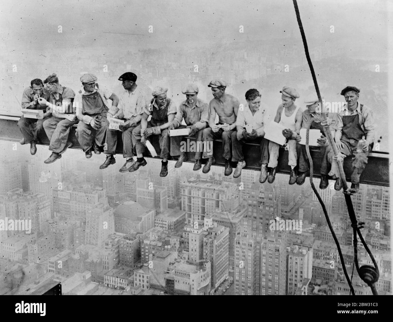Lavoratori a pranzo su una trave, in alto sopra la strada. Novembre 1932 Foto Stock