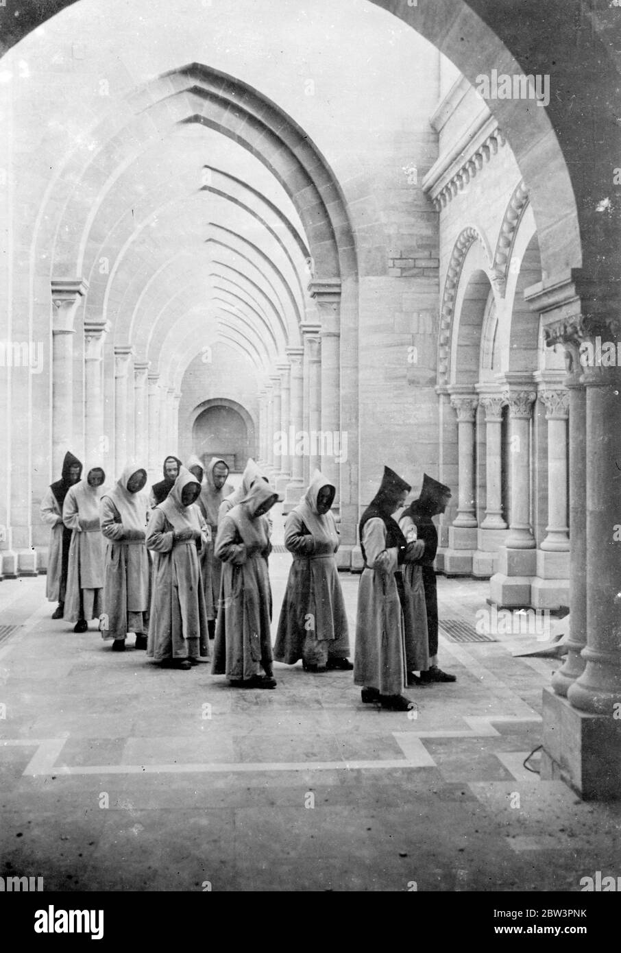 Cinquantatreesimo abate di Orvial installato con cerimonia antica. Con un cerimoniale impressionante e dignitoso Dom Marie Albert von der Cryssen fu installato nella nuova chiesa come cinquantatreesimo Abate di Orval , Belgio . La nuova chiesa in cui si è svolta la cerimonia di installazione è appena stata completata e sorge dalle rovine di un'altra chiesa che si trovava sul sito per molti anni . Spettacoli fotografici , monaci con vongole e rivestiti di grigio che attraversano la nuova chiesa di Orval durante la cerimonia . 10 maggio 1936 Foto Stock