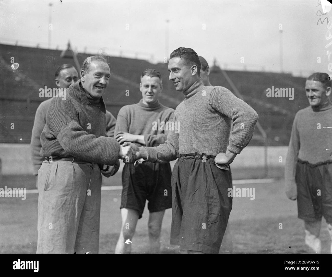 Sam Weaver si unisce al nuovo team dopo il trasferimento a Chelsea da Newcastle . Pioneer of the long' throw in' può lanciare la palla da touchline a goalpost , Sam Weaver , il Newcastle United e l'Inghilterra ha lasciato il mezzo di ritorno che è stato trasferito a Chelsea , si è Unito alla sua nuova squadra al Stamford Bridge , Londra , Ground . Weaver capitanò Newcastle la scorsa stagione , facendo 31 apparizioni di campionato . Nel 1932 fu chiuso contro la Scozia e nel 1933 contro la Scozia e l'Irlanda. Foto mostra , Sam Weaver ( a destra ) scuotendo le mani con Tommy Law , il Chelsea indietro , come è stato ricevuto dai membri della sua nuova squadra A. Foto Stock