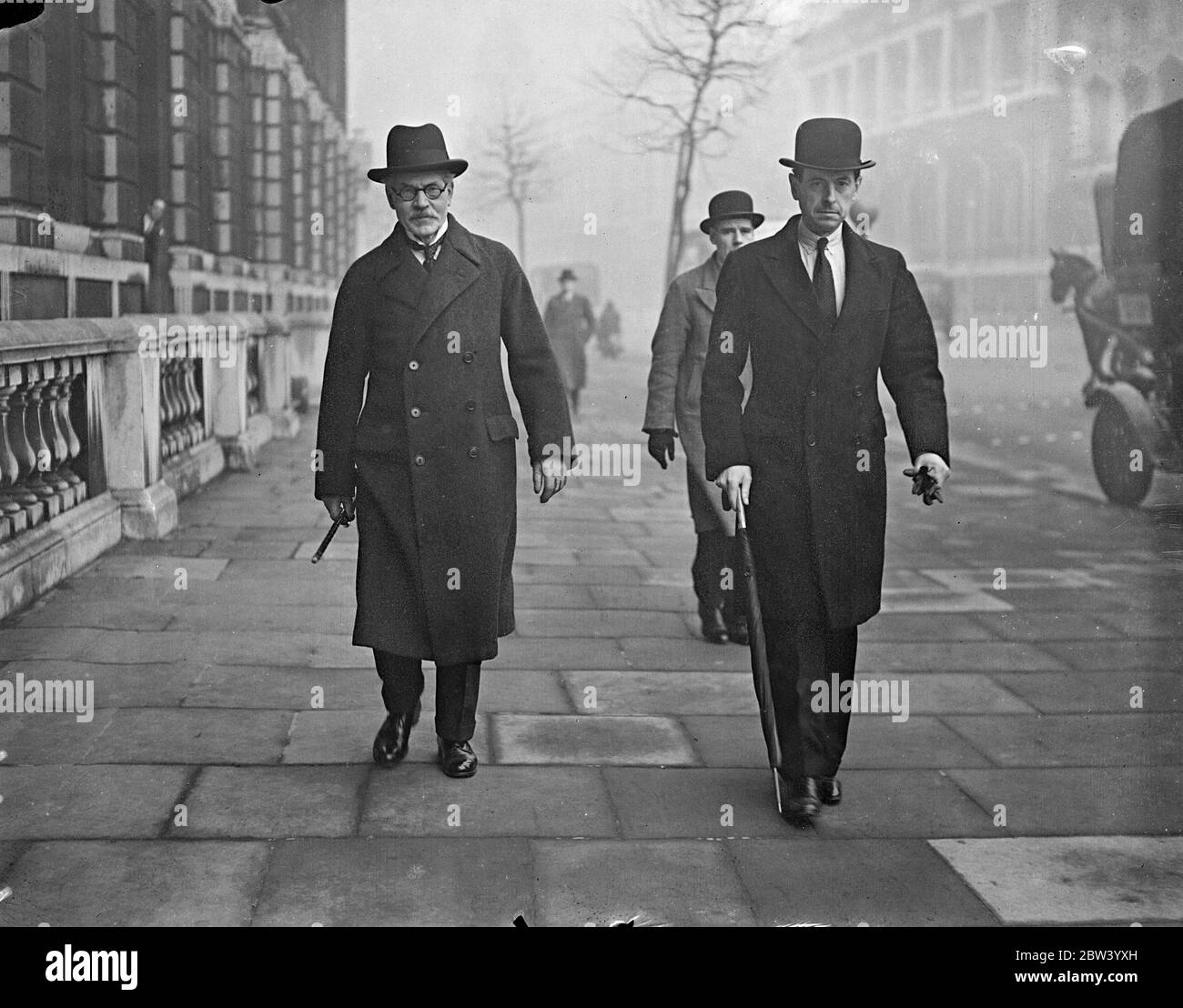 Ramsay MacDonald, Signore Presidente del Consiglio, parte per la Camera. Abdicazione lettura di legge. Ramsay MacDonald, che in qualità di presidente del Consiglio presiederà la riunione del Consiglio privato per esaminare l'adesione, ha lasciato gli uffici del Consiglio privato a Downing Street per la Camera dei Comuni, dove il disegno di legge che dà effetto all'abdicazione del re Edoardo viene affrettato a legiferare. E' l'unica volta che il consiglio si riunisce in toto. Foto: Ramsay MacDonald (a sinistra) lasciando gli uffici del Consiglio privato a Downing Street. 11 dicembre 1936 Foto Stock