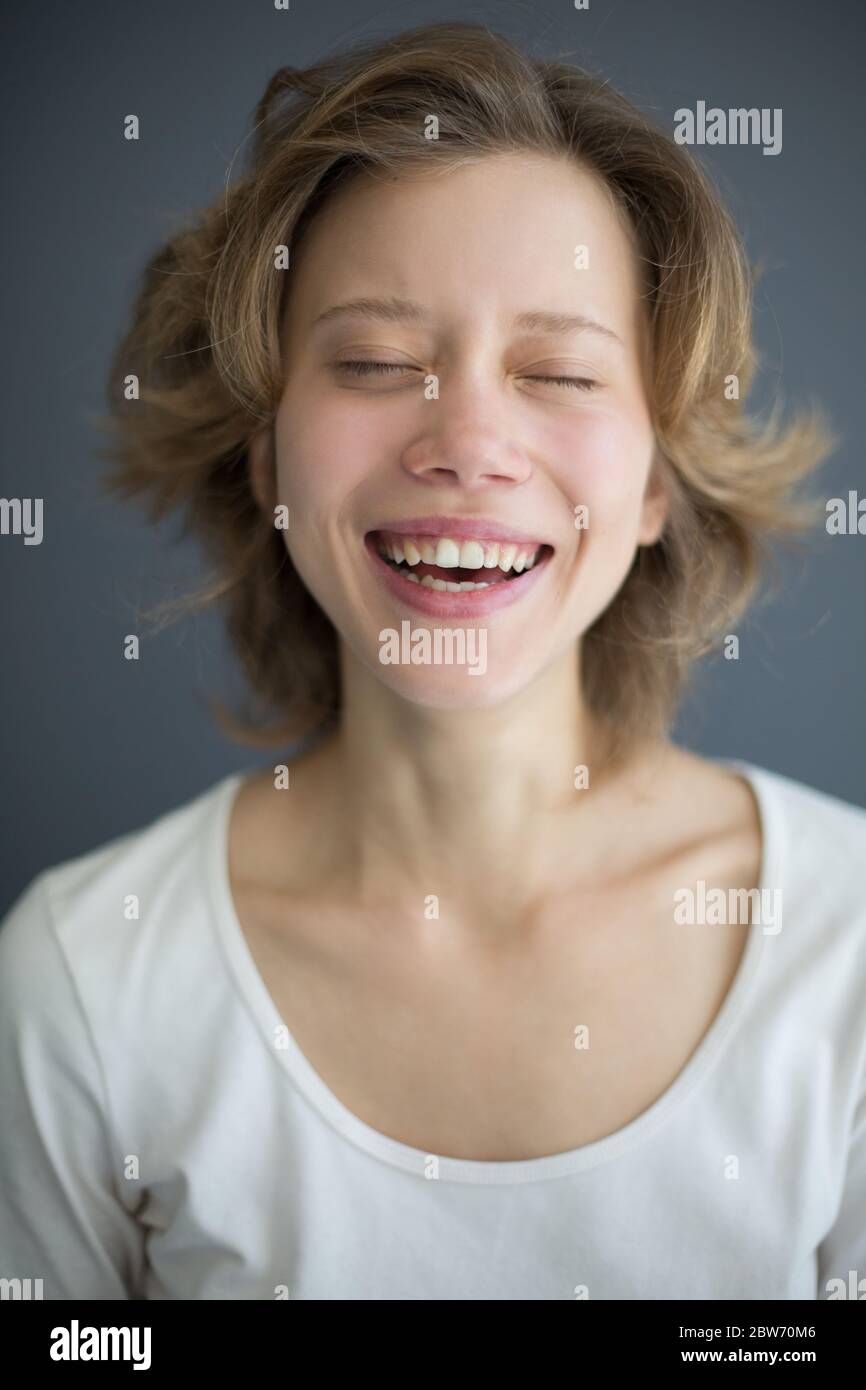 Ritratto di ridere bella donna che chiude gli occhi sognando Foto Stock