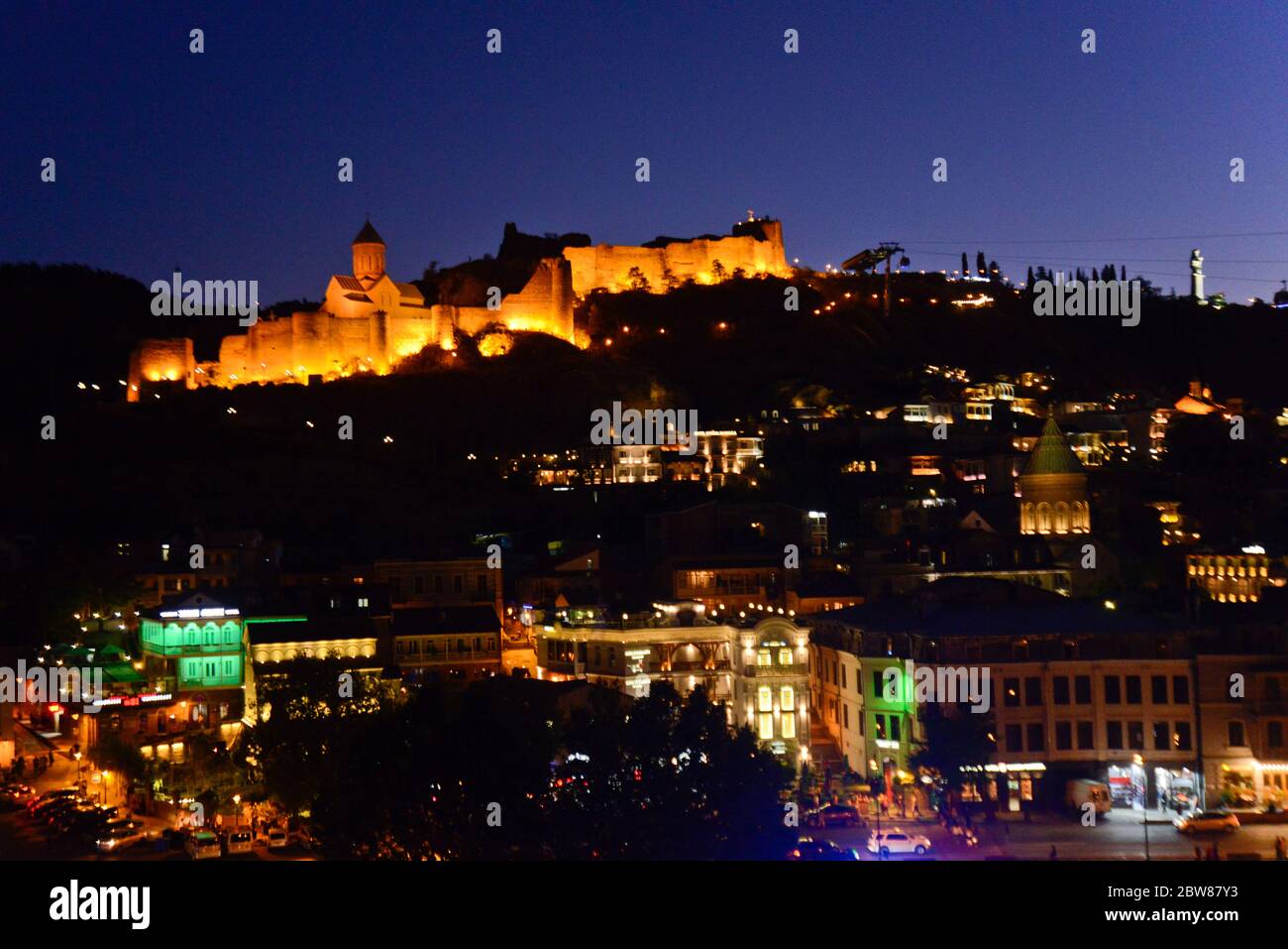 Tbilisi: Vista panoramica alla sera / crepuscolo, con la Fortezza Narikala, il fiume Kura, Sololaki Hill. Repubblica di Georgia Foto Stock