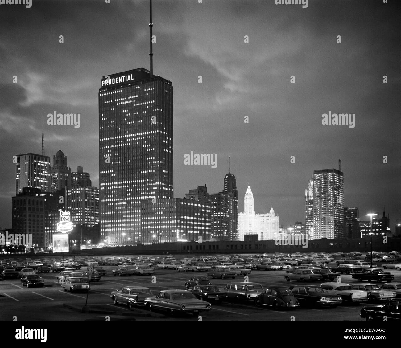 SKYLINE NOTTURNO DEGLI ANNI '60 DI EDIFICIO PRUDENZIALE E LUMINOSO EDIFICIO WRIGLEY DA MONROE DRIVE CHICAGO ILLINOIS USA - R19508 HAR001 HARS VEICOLI EDIFICE ILLINOIS PRUDENZIALE BIANCO E NERO HAR001 VECCHIO STILE PARCHEGGIO WRIGLEY Foto Stock