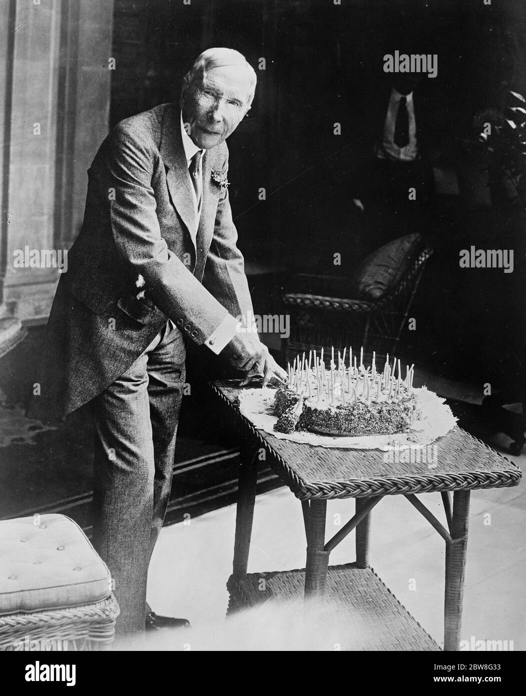 L'uomo più ricco del mondo , John D Rockefeller tagliando la sua torta di compleanno . 18 luglio 1929 Foto Stock