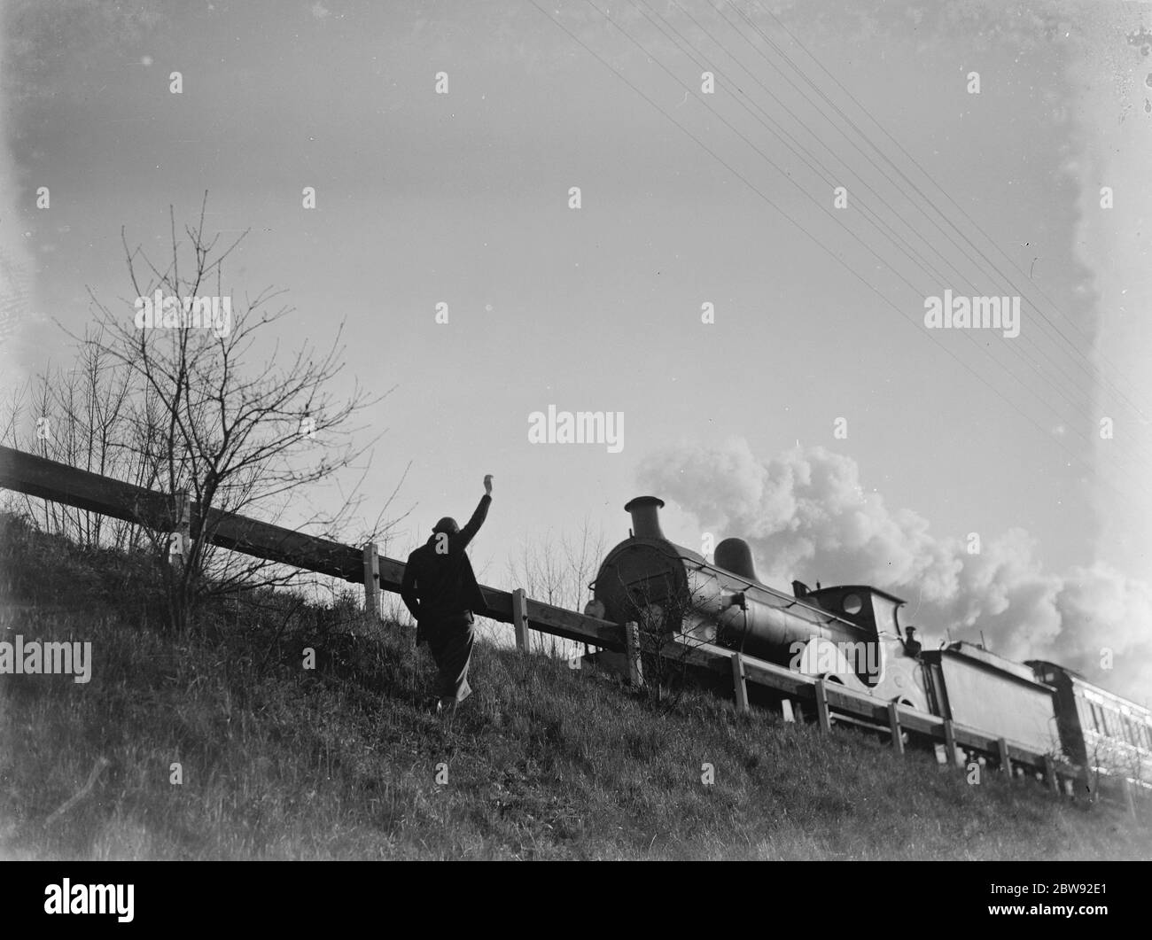 Muriel Haken si ondeggia verso un treno di passaggio da un argine ferroviario. 1939 Foto Stock