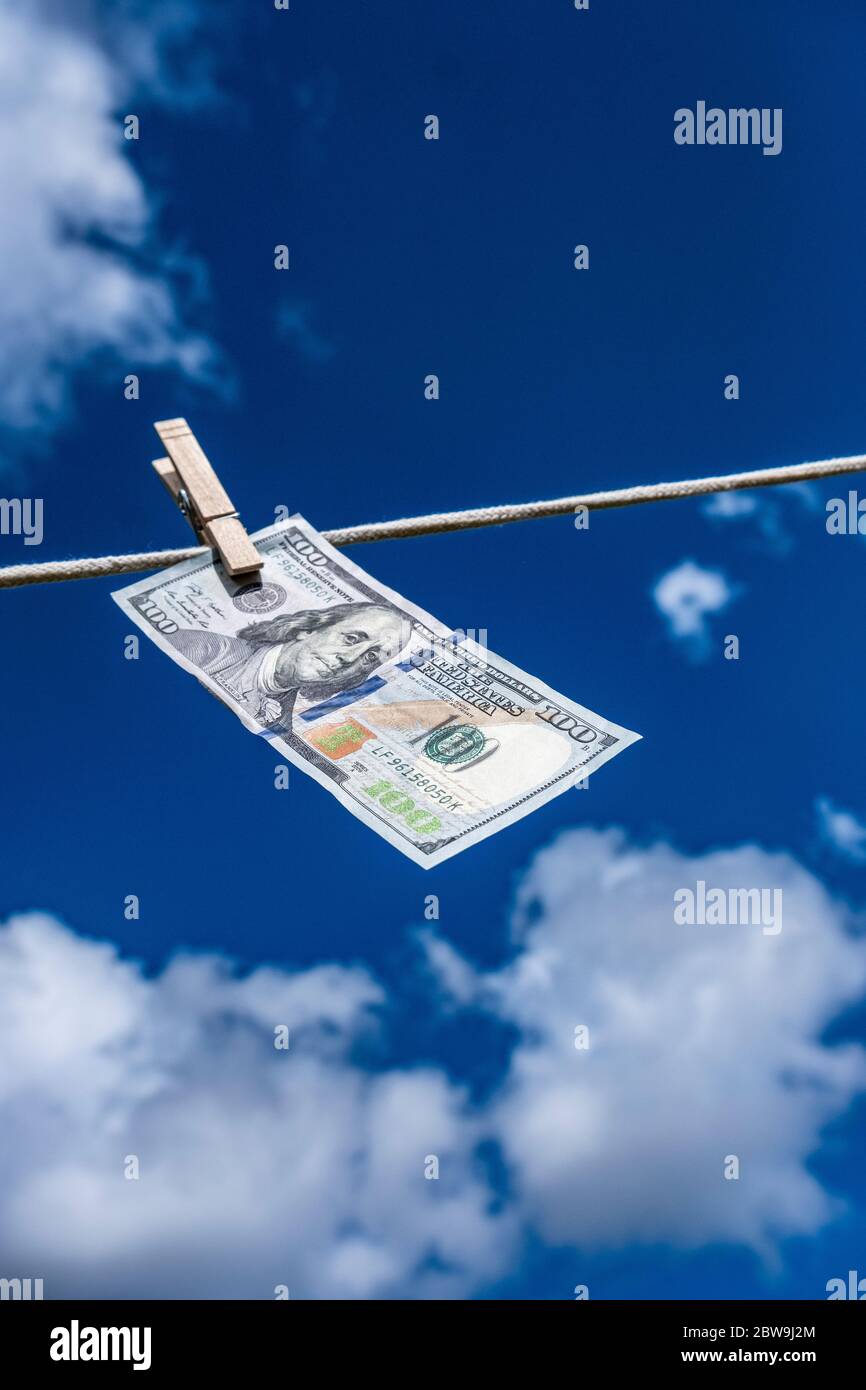 Un centinaio di dollari di bolletta che asciuga su stendibiancheria contro cielo Foto Stock