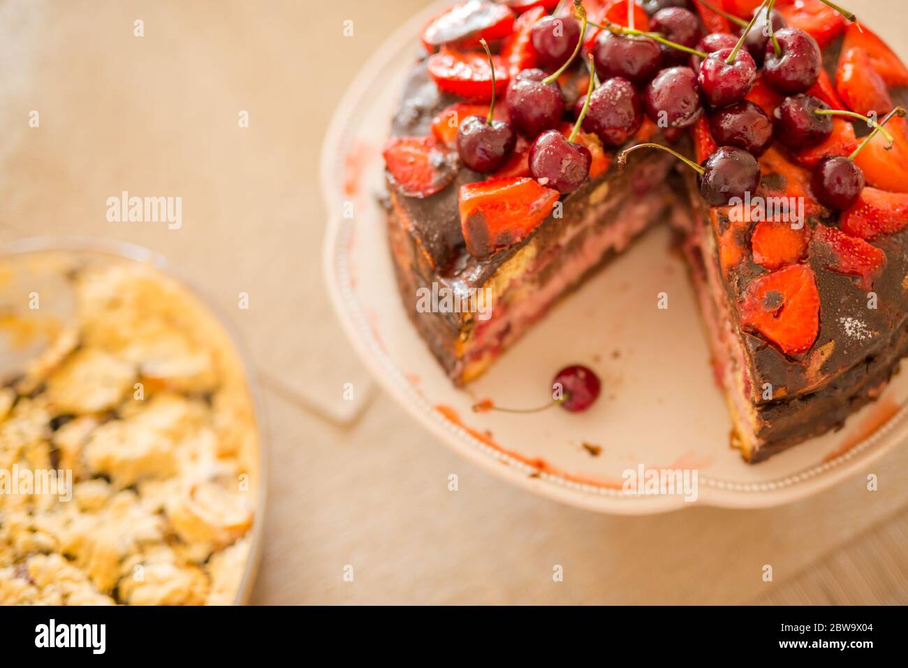 Dolce dolce tradizionale fatto in casa con torta al cioccolato con ciliegia, lampone, curry su sfondo di legno d'annata. Foto di cibo scuro Foto Stock
