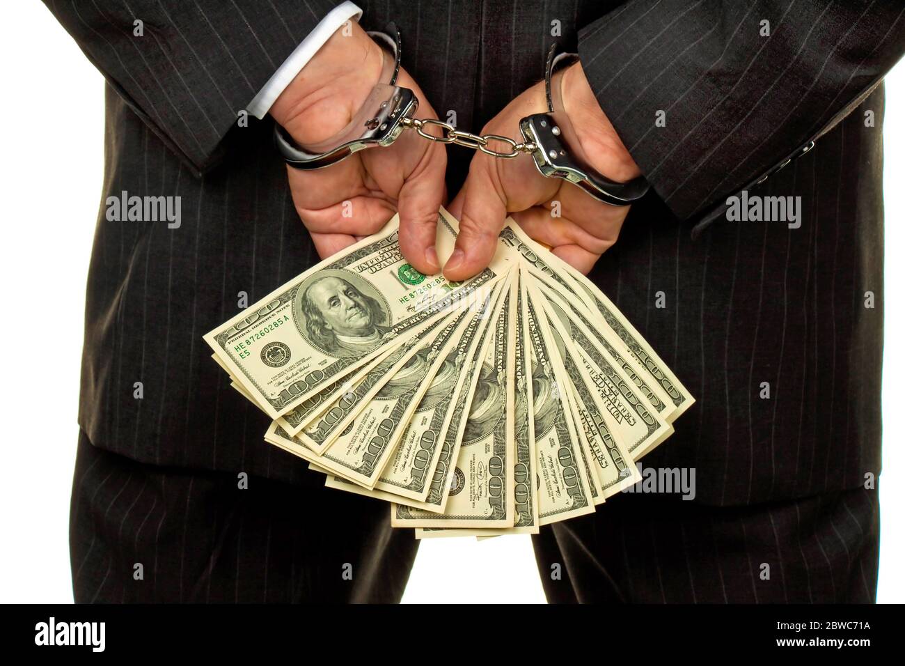 Manager mit Dollar Geldscheinen in der Hand, Hanschellen, verhaftet, Schwarzgeld, Foto Stock