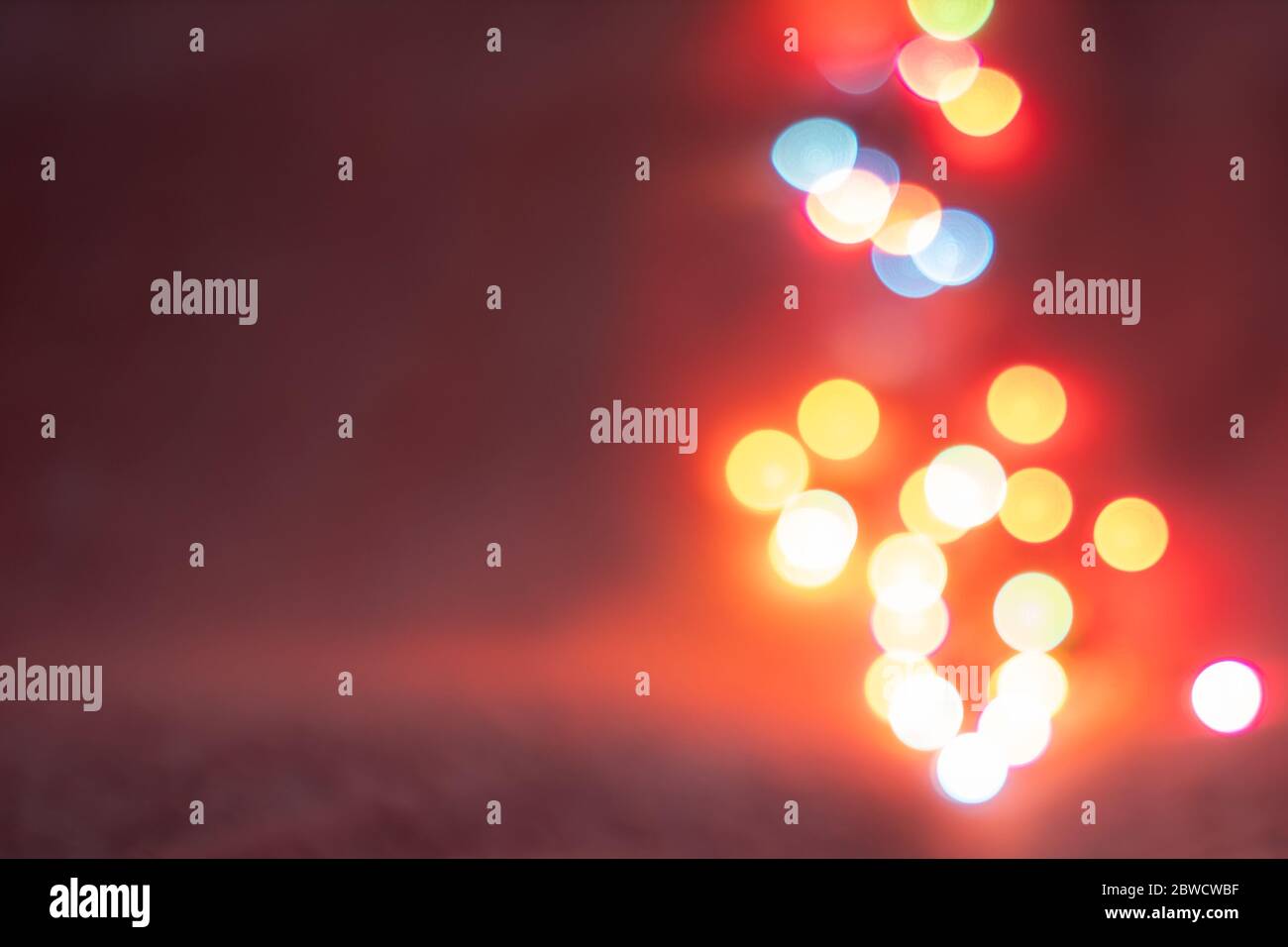 Astratto sfondo bokeh colorato sfocato con spazio di copia. Sfondo blu, rosso e dorato scintille scintillanti con effetto di bagliore, conca festiva e festiva Foto Stock