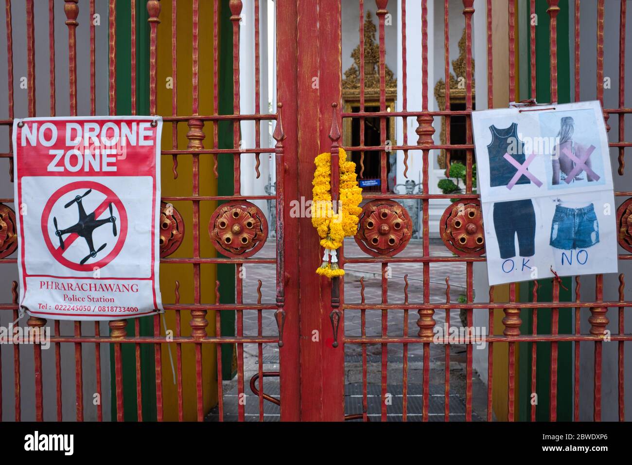 All'ingresso dell'iconico tempio Wat po a Bangkok, in Thailandia, i cartelli informano i visitatori del codice di abbigliamento e vietano l'uso dei droni Foto Stock