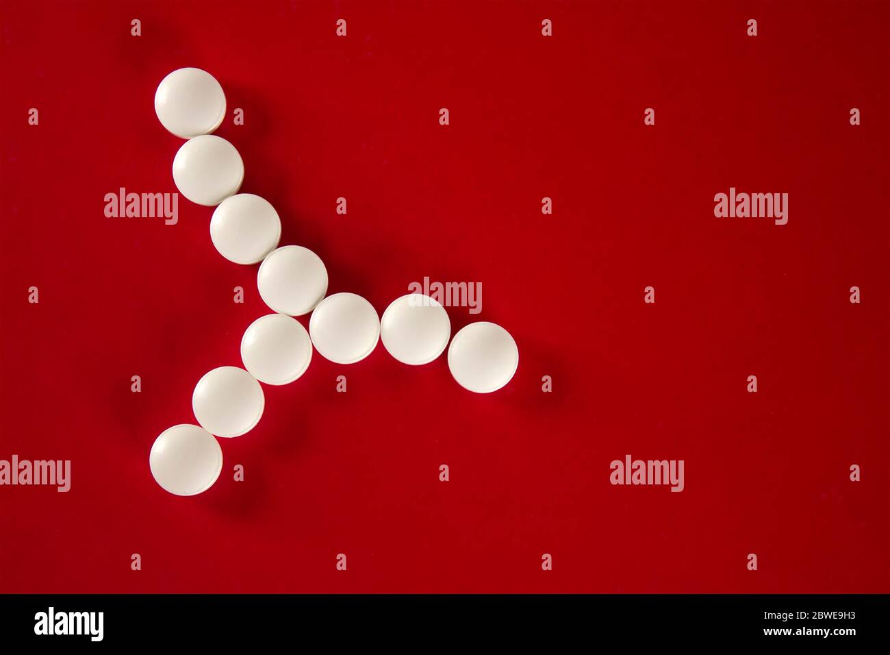Cellula batterica composta da compresse bianche con spazio di copia per il testo su sfondo rosso, vista dall'alto Foto Stock